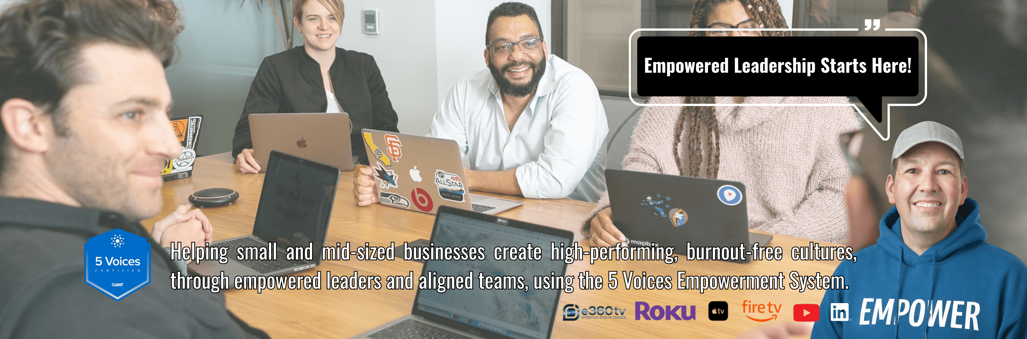 Small team gathers around a meeting table in a Board Room